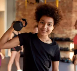 Kid lifting weights for youth exercise program