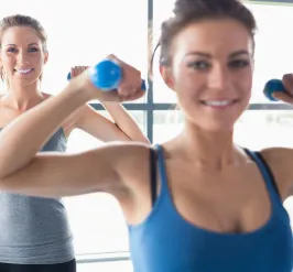 Women lifting hand weights in the gym