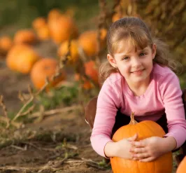 Girl holding a pumpkin