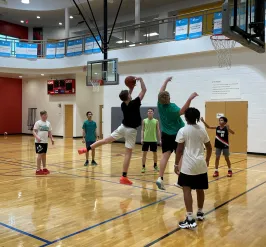 Teens playing basketball