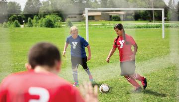 Kids playing in youth soccer league game